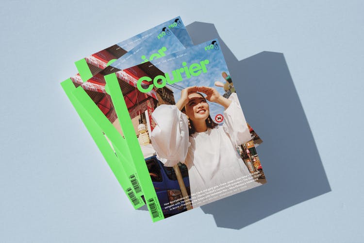 Image shows a stack of the redesigned 50th issue of Courier magazine, with lime green title font and spine, and a photograph of one of Bao's co-founders looking up to the sky and shielding her eyes with her hands